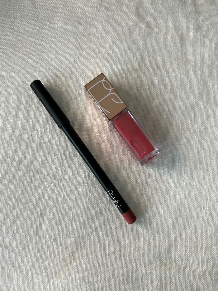 The Nars Christmas 2025 Lip Shine &amp;amp; Lip Duo on a white linen background