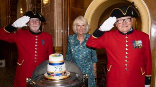 Camilla, Duchess of Cornwall poses with Chelsea Pensioners as she celebrates her 75th birthday at a lunch