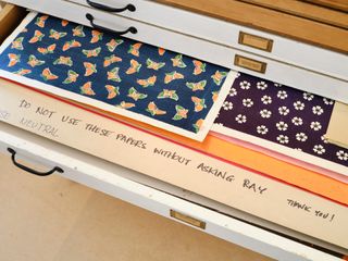 A drawer with patterned paper by Ray Eames
