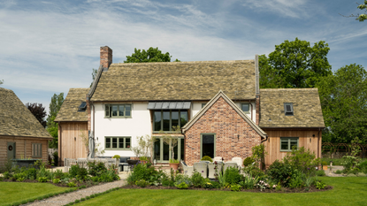 a large country cottage with a well maintained garden and two extensions.