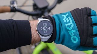 Garmin Forerunner 165 on the wrist of a cyclist