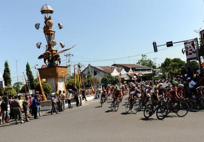 Riders pass through Tabuik Monument, in Pariaman