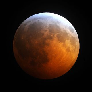 This photo of the total lunar eclipse of Dec. 20, 2010 by Jimmy Westlake shows the blue edge to Earth's shadow set against the reddened moon.