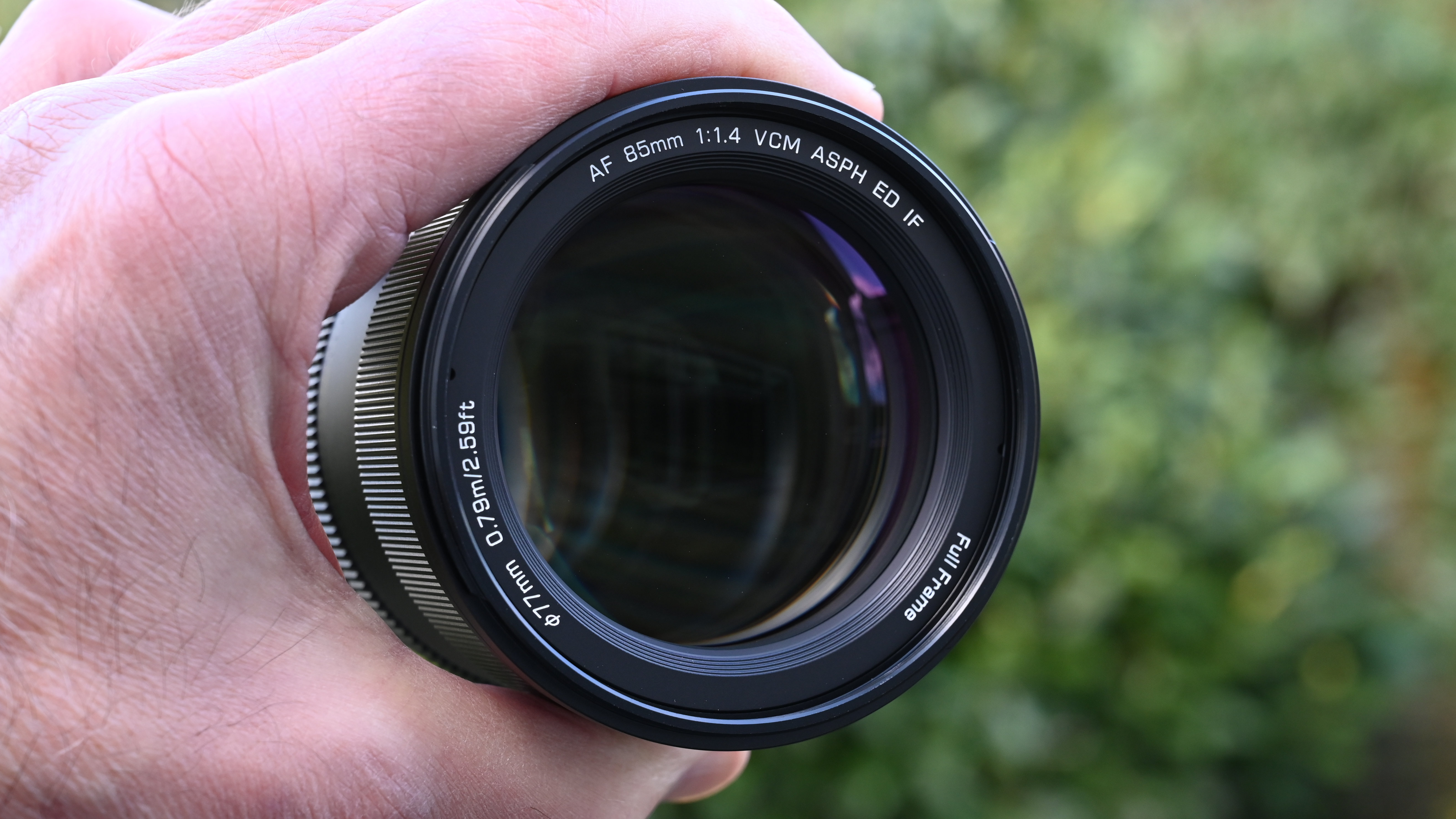 Viltrox AF 85mm f/1.4 Pro product shot, lens in hand