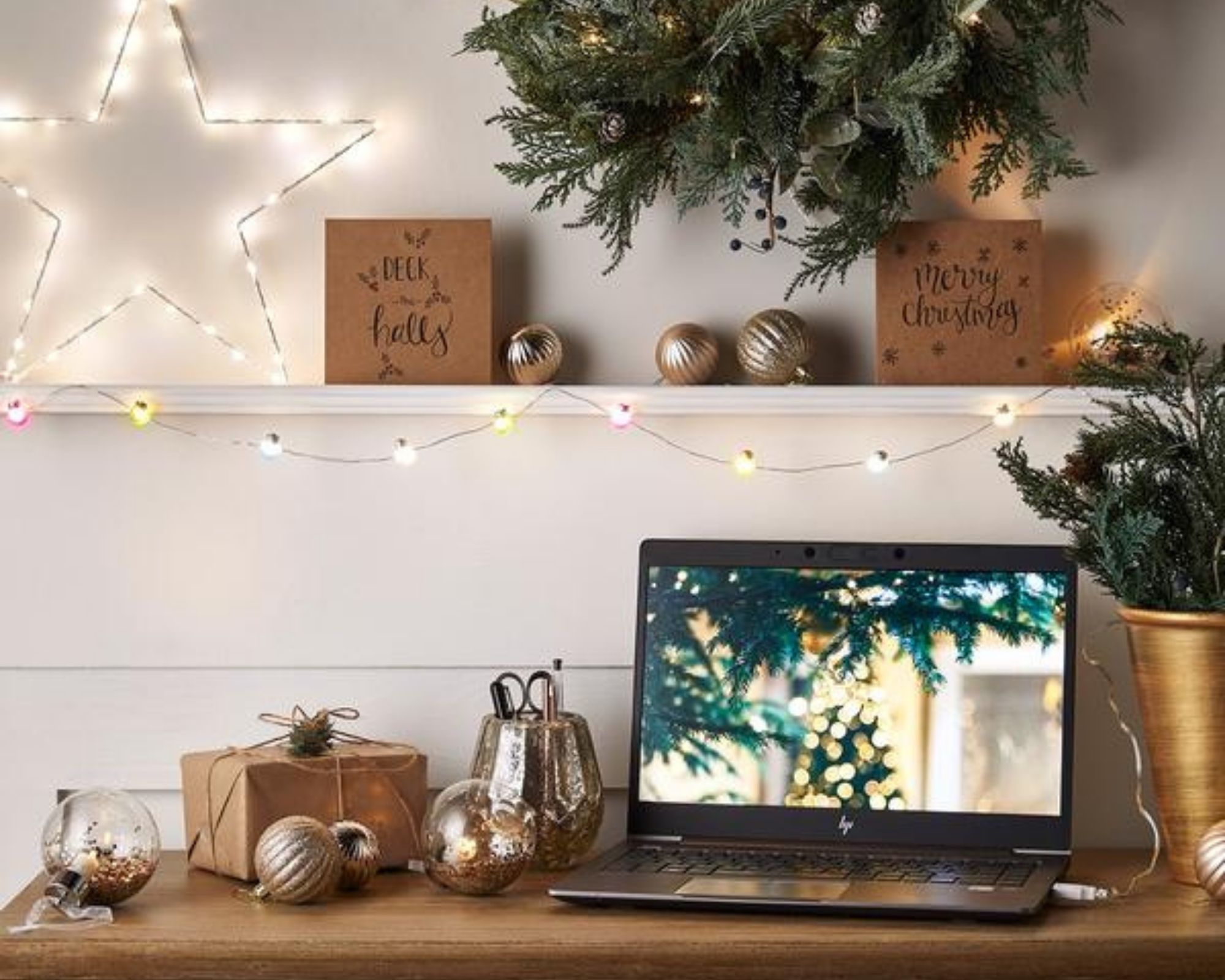 10 Multi Coloured Micro Fairy USB Lights draped over a desk and plugged into a laptop