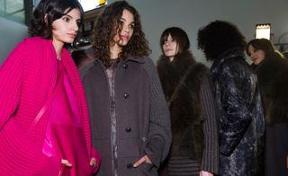 Akris models wearing coats