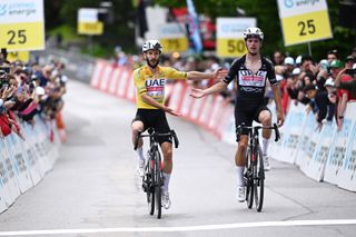 Adam Yates and UAE Team Emirates team-mate Joao Almeida cross the finish line together on Stage 7 of the Tour de Suisse 2024