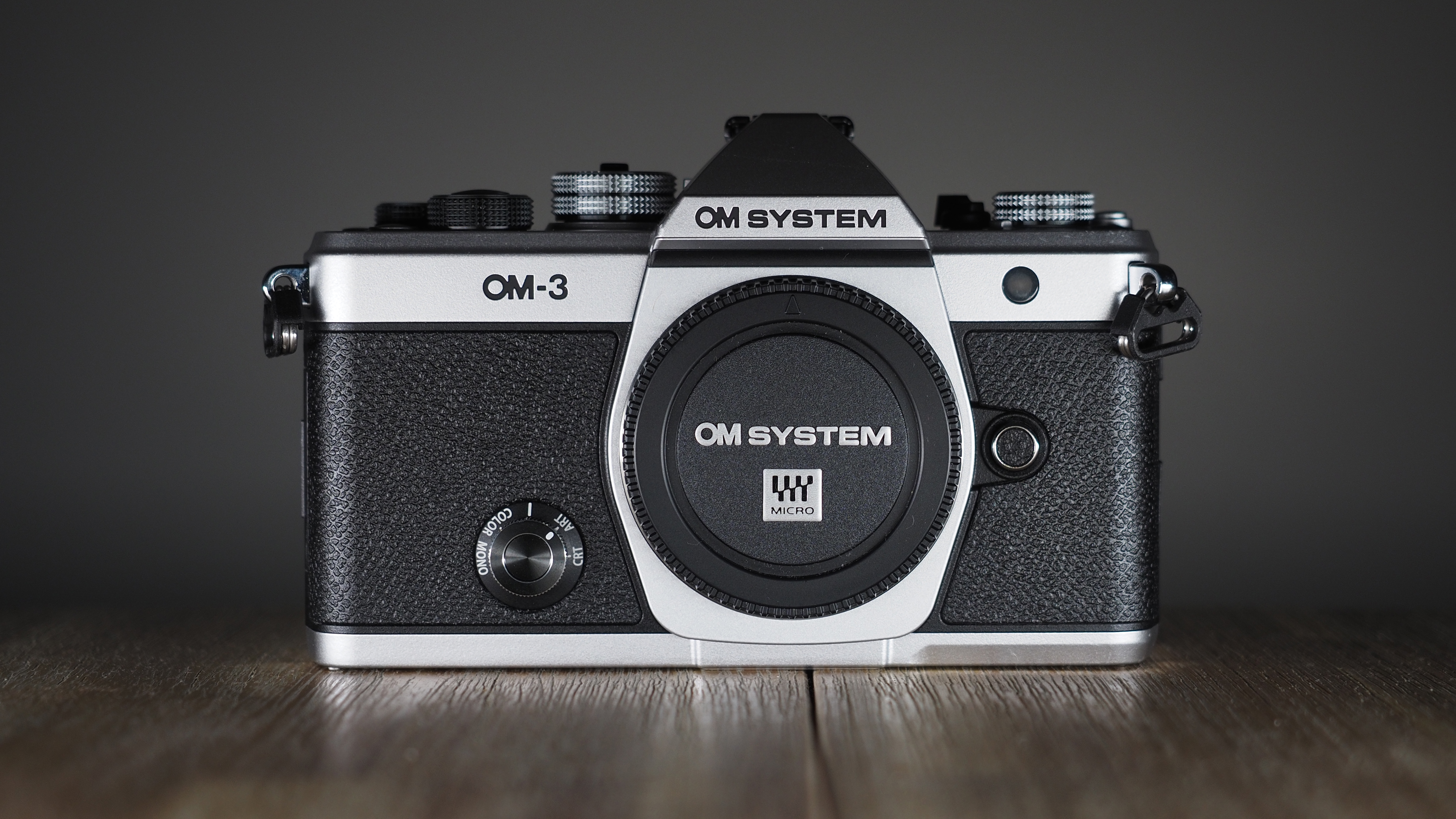 OM System OM-3 on a wooden surface