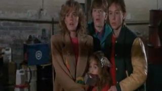 The cast of Adventures In Babysitting looking scared.