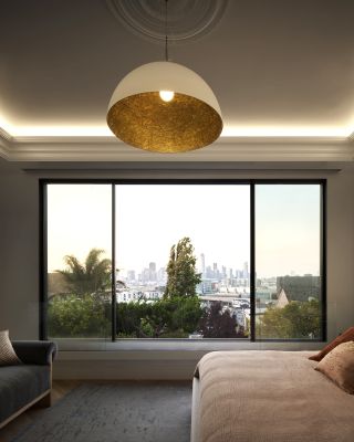 A bedroom with gray walls and pink bedding