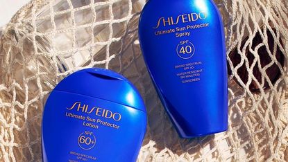 Shiseido sunscreens laying on a beach bag