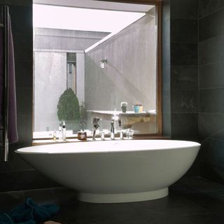bathroom with tiled walls and flooring