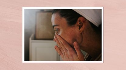 Image of woman applying skincare with a pink background