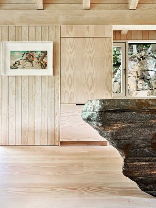 a kitchen with a big natural stone island