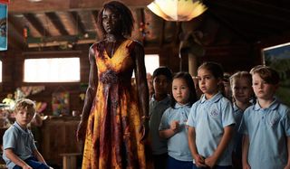 Little Monsters a bloody Lupita Nyong'o stands in front of her students