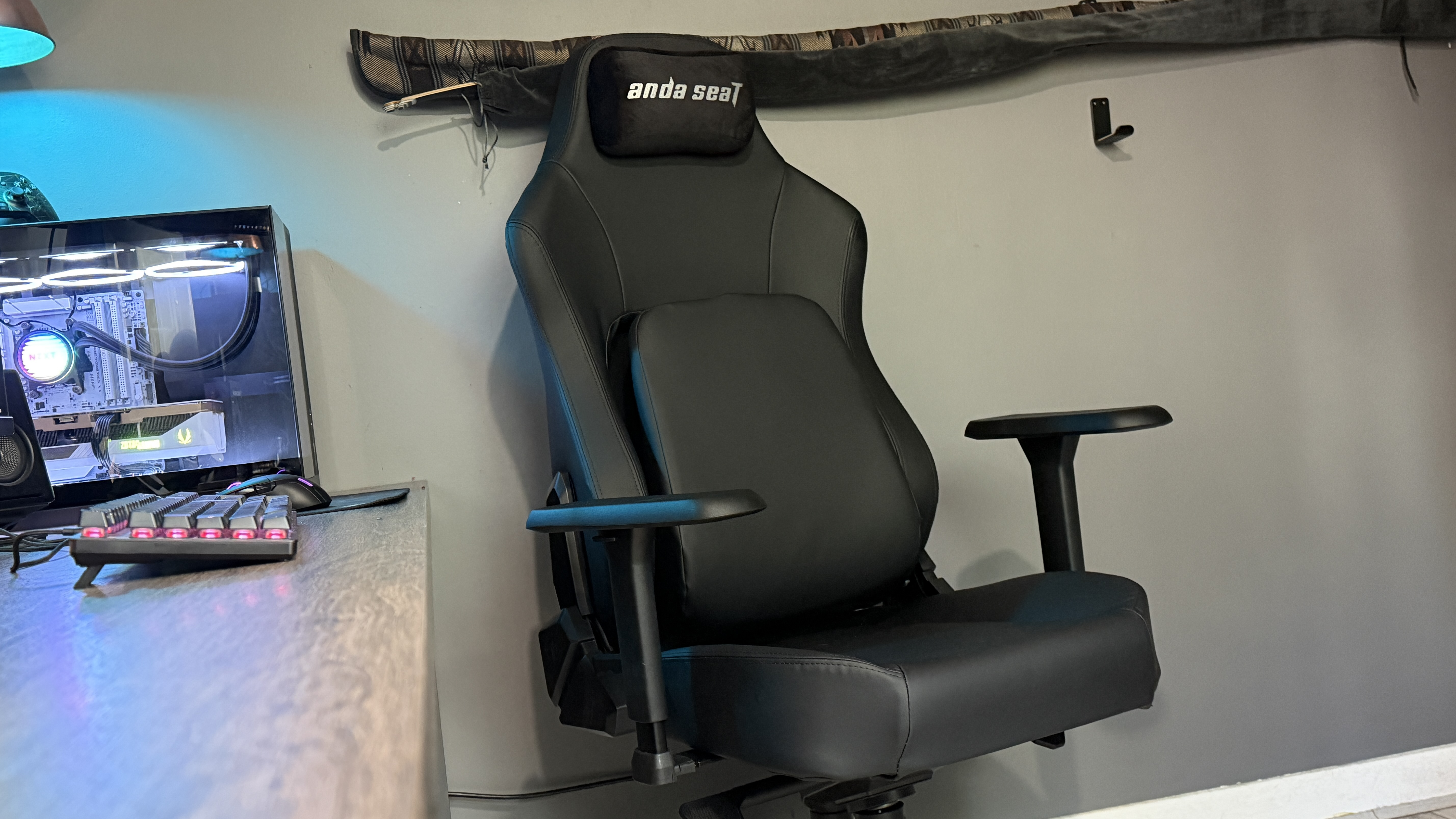 The AndaSeat Phantom 4 Pro in a brightly lit home office environment in front of a gaming PC.