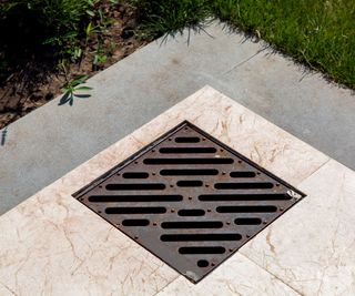 Iron catch basin grate in a patio