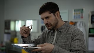 Trigger examining a bomb component in NCIS: Sydney