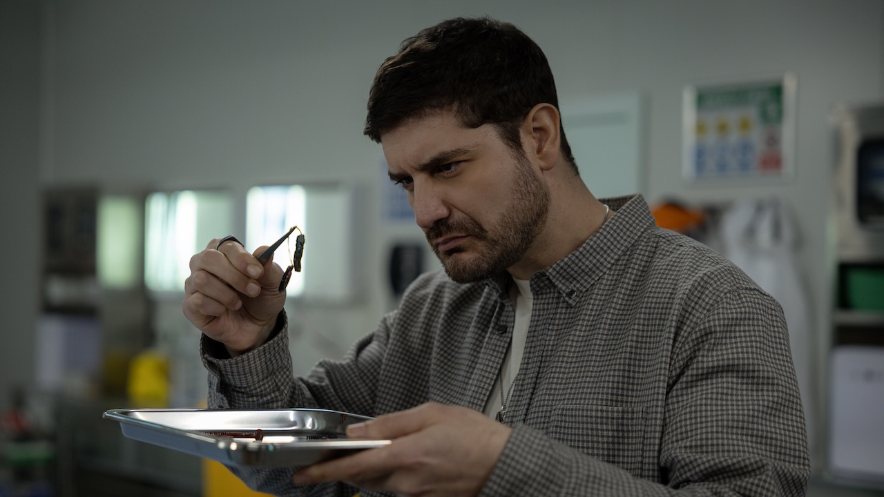 Trigger examining a bomb component in NCIS: Sydney