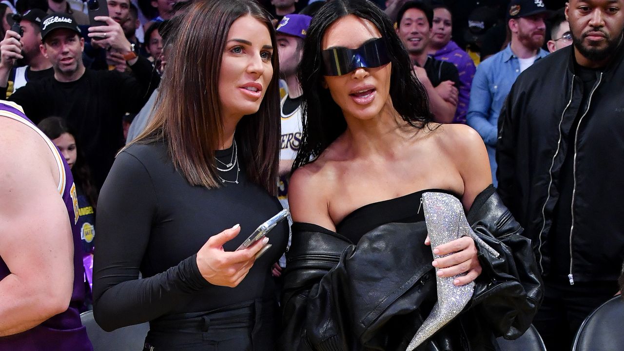 Kim Kardashian at Lakers game carrying an embellished stiletto-style handbag 