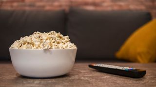 A bowl of popcorn on a coffee table.
