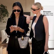 collage featuring Arranging Things Book by Colin King, a street style shot of two women looking at a cell phone in chic outfits and Necessaire body lotion