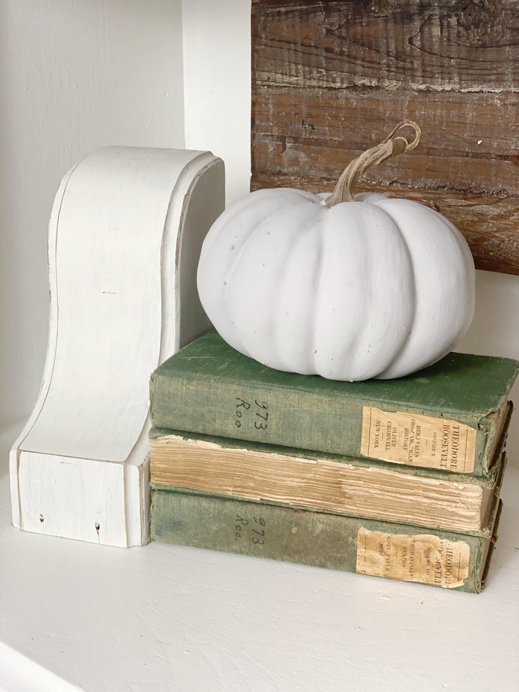 Concrete look pumpkin on stack of books