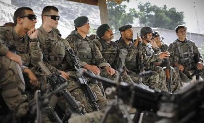 Afghan soldiers sit alongside U.S. soldiers during a pre-patrol briefing in Afghanistan on June 26, 2012.