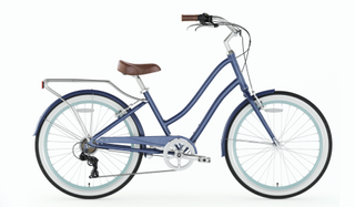 A light blue cruiser style electric bike with panniers on the back