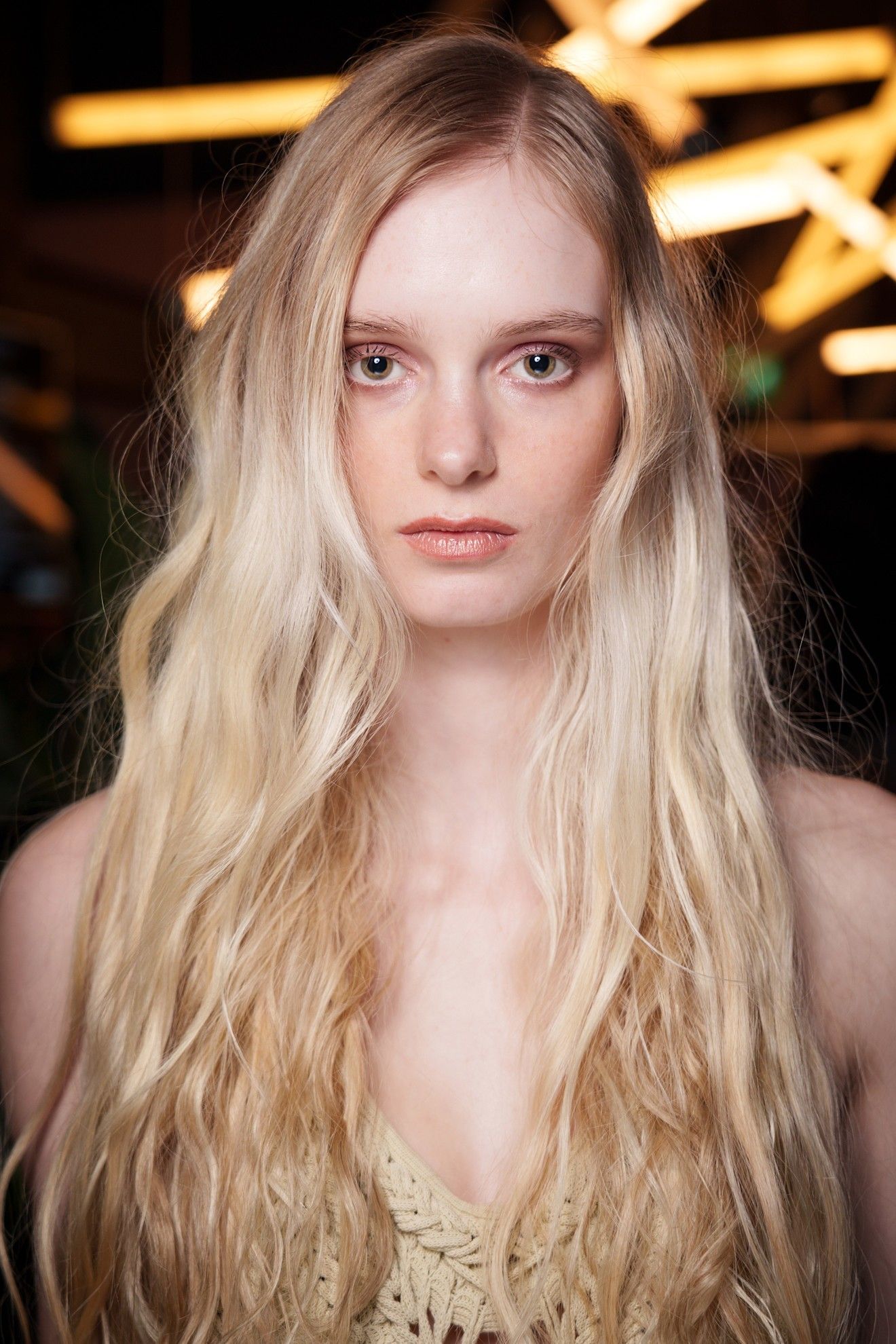 A model with long, shattered layers in her blonde hair