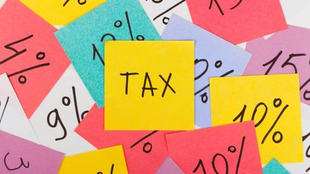 Brightly coloured post-it notes showing percentages and the word 'tax'
