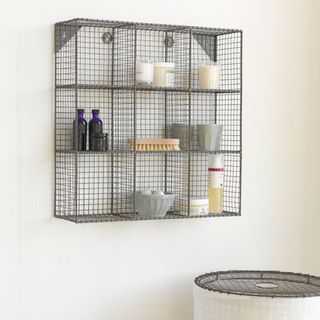 white wall with metal wall storage and laundry bins