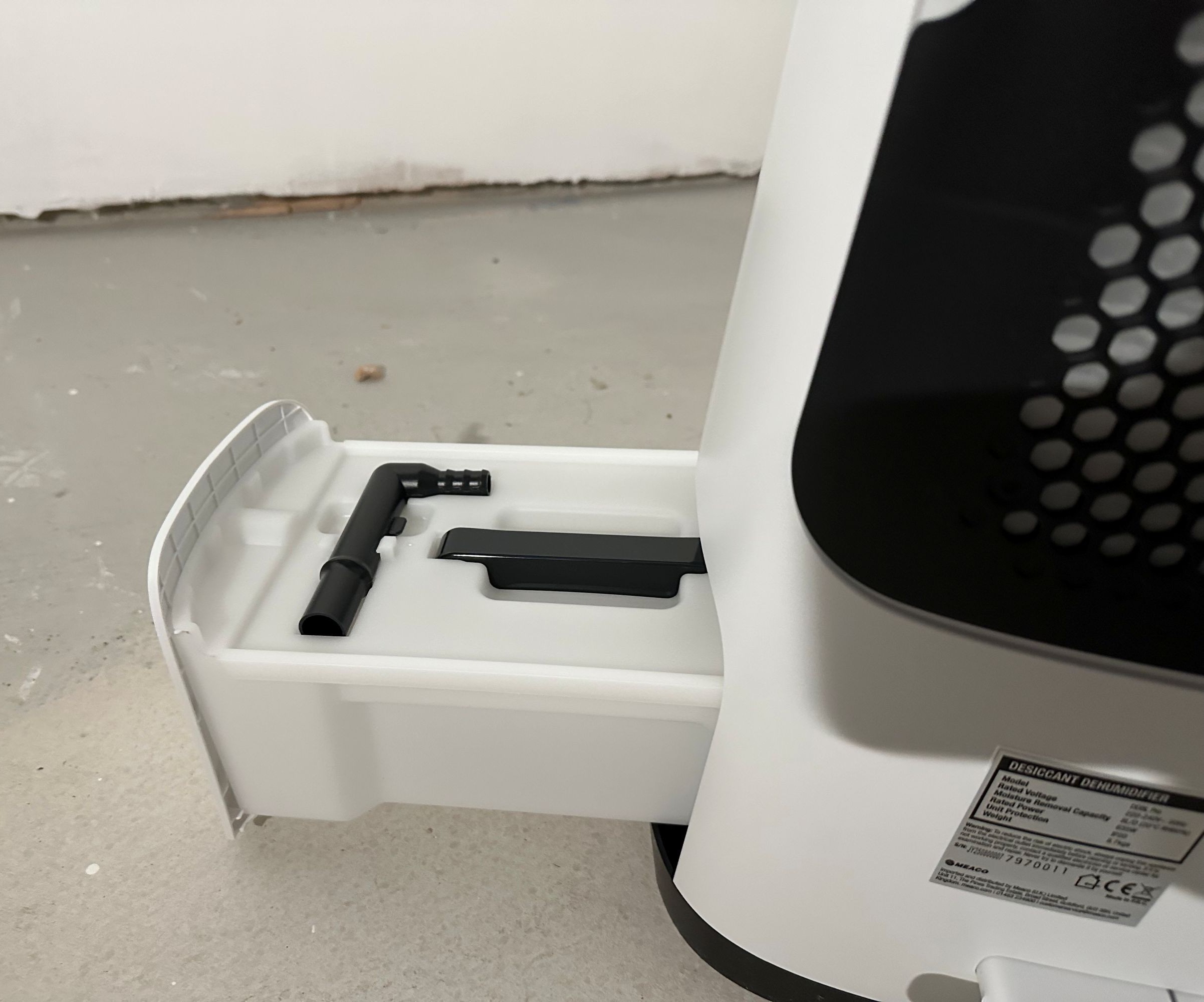 The water collection tray open on a dehumidifier