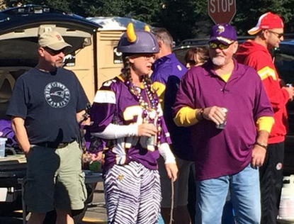 Vikings fan in Adrian Peterson jersey tailgates while brandishing a switch