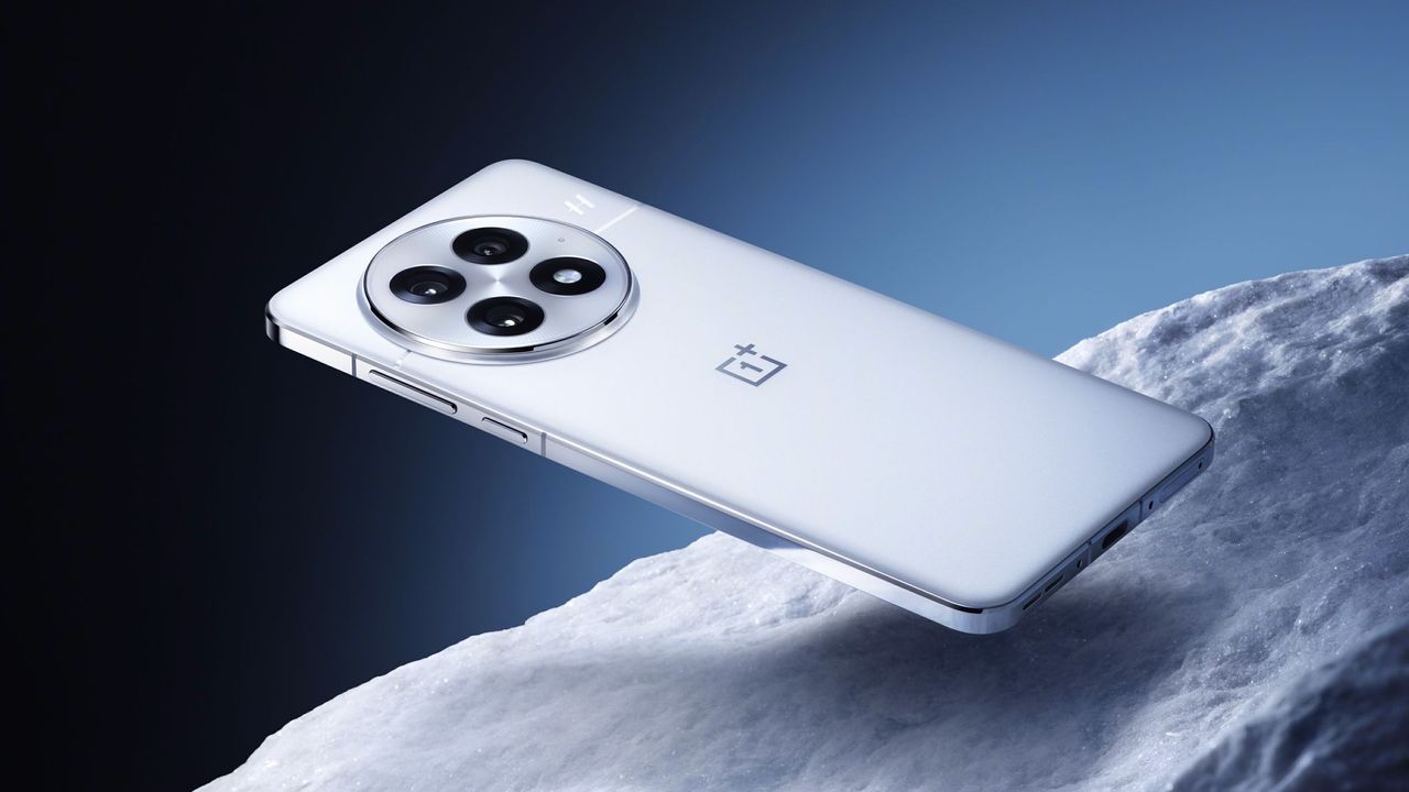 OnePlus 13 phone in white floating above a white stone