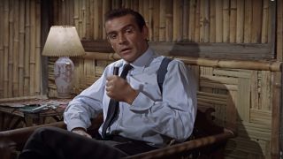 Sean Connery sits to disassemble his equipment in Dr. No.