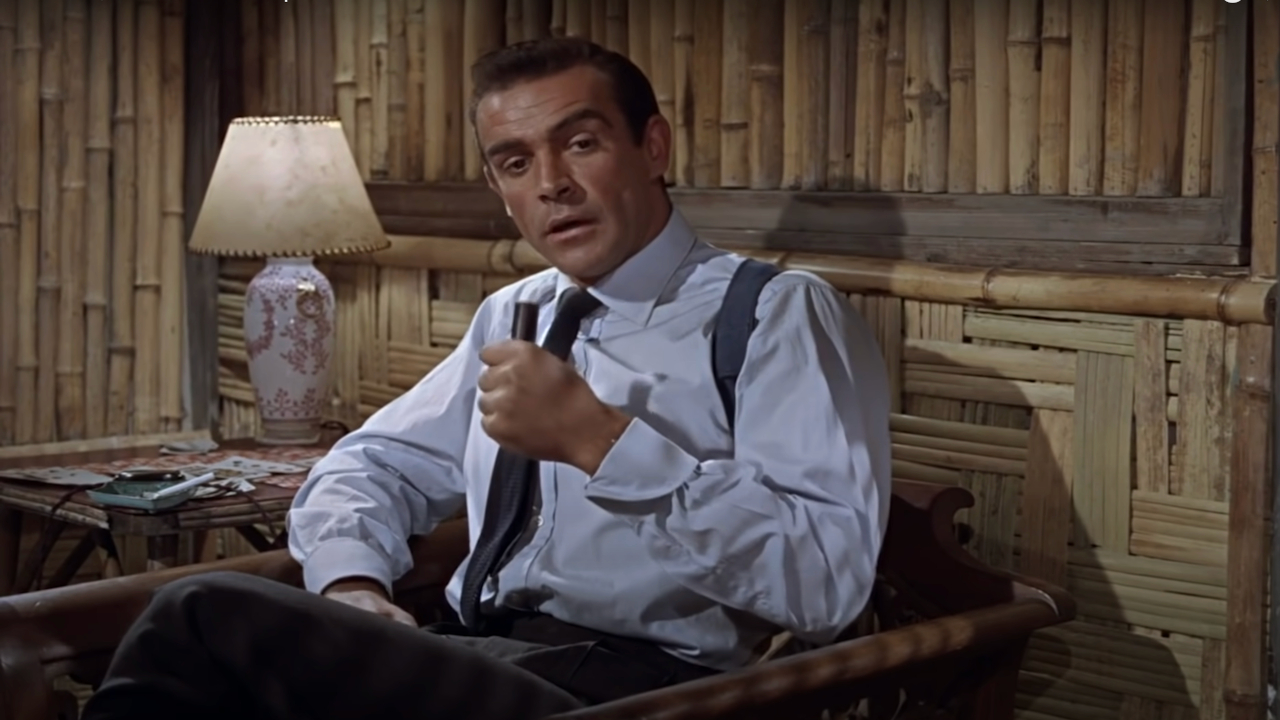 Sean Connery sits to disassemble his equipment in Dr. No.