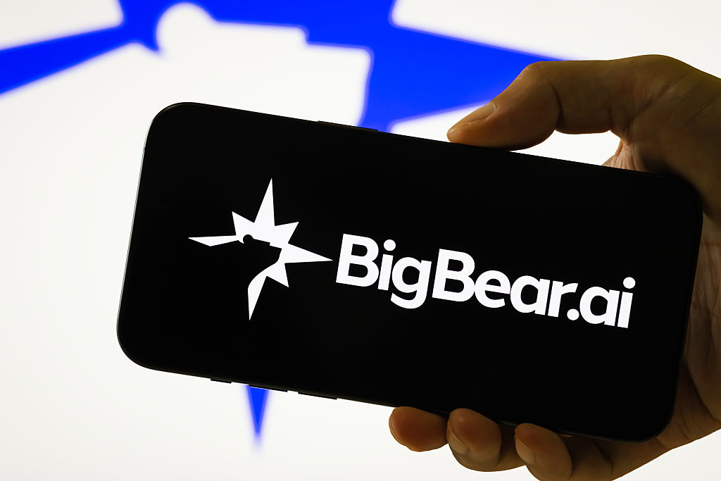 BigBear.ai logo on a smartphone with blurred logo in the background