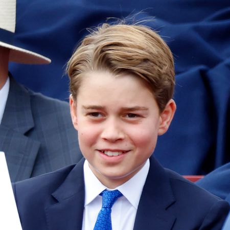 Prince George wearing a suit and tie smiling