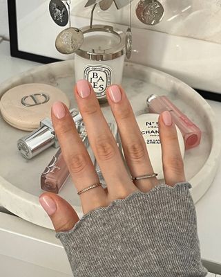 A woman wearing Essie's Sheer Fantasy nail polish