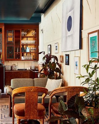 The hotel lobby of a Miami stay is plastered in wide wall art and mid-century modern as well as modern rustic furniture in woody tones.