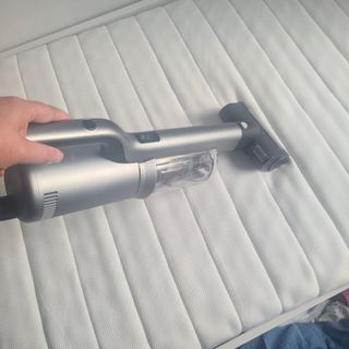 Vacuuming a mattress with the Roidmi RS60 mattress cleaner