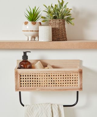 Rattan cane wooden caddy hung on wall of bathroom