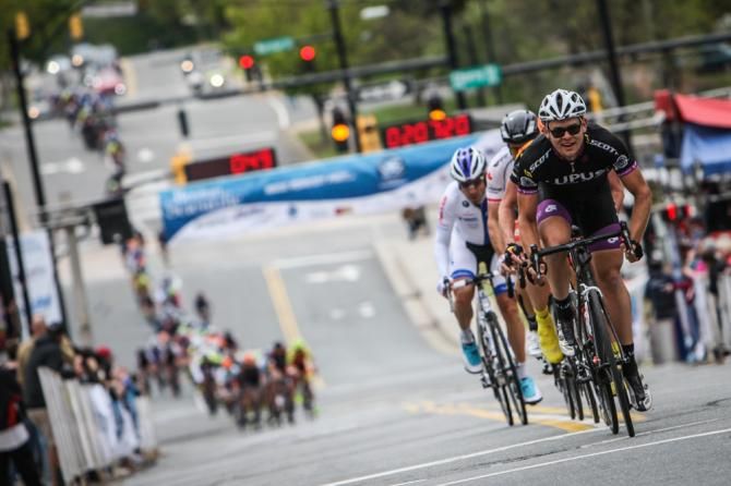 A break in the men's race passes the finish line.