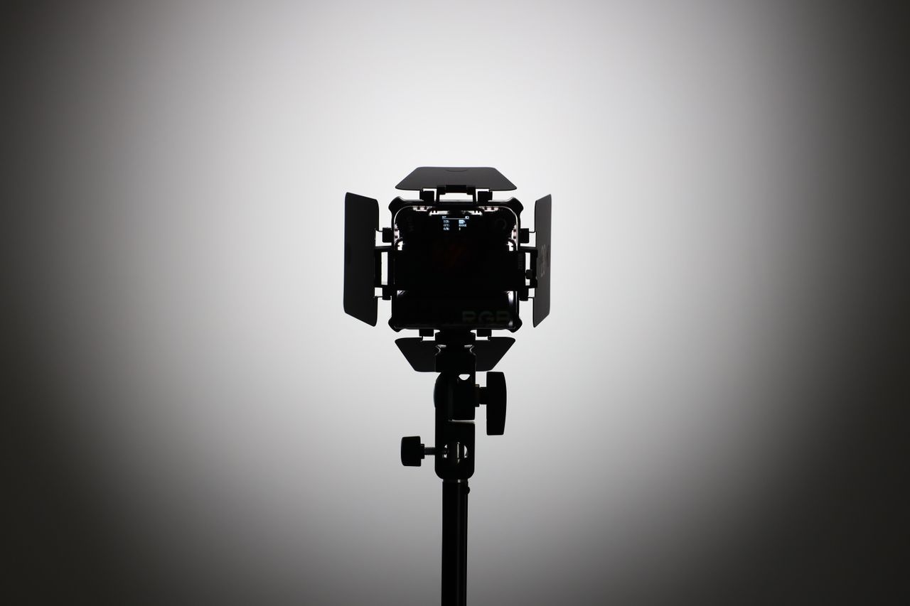 Zhiyun FIVERAY M20C LED panel on a light stand and pointed at a wall
