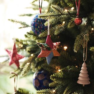 A Christmas tree with decorations from the John Lewis Trinket & Treasure range