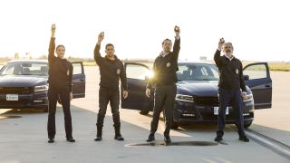Katrina Law, Wilmer Valderrama, Sean Murray and Gary Cole holding up badges in NCIS