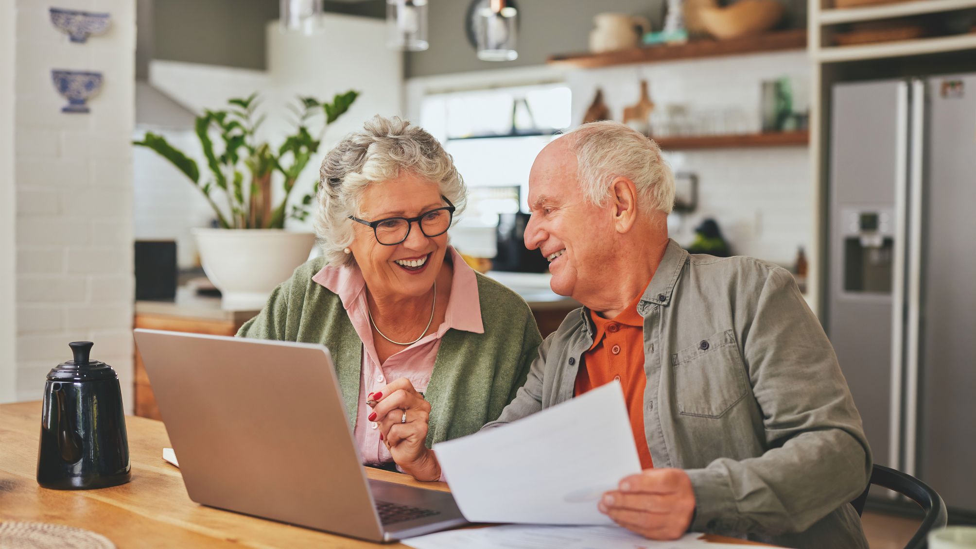A couple discussing their personal finances in front of a laptop