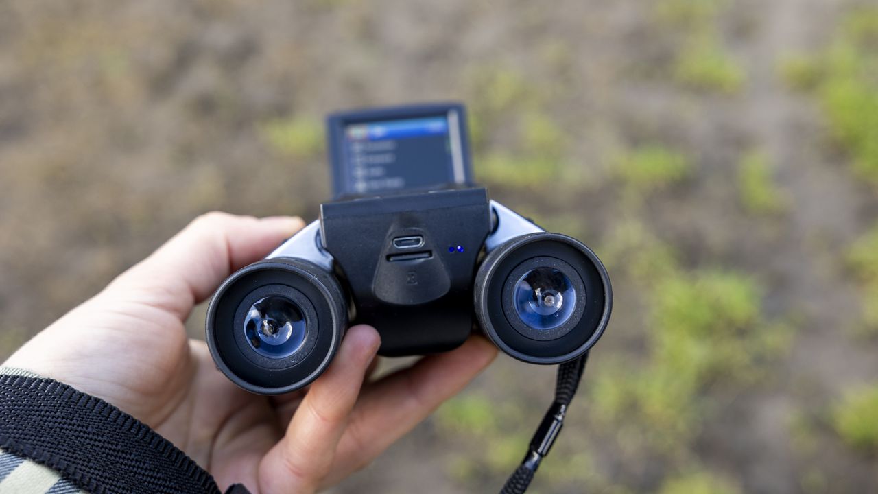 Camonity 12 x 32 digital binoculars in a ladies hand