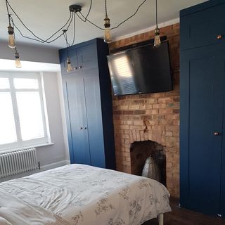 Bedroom with built in blue wardrobes